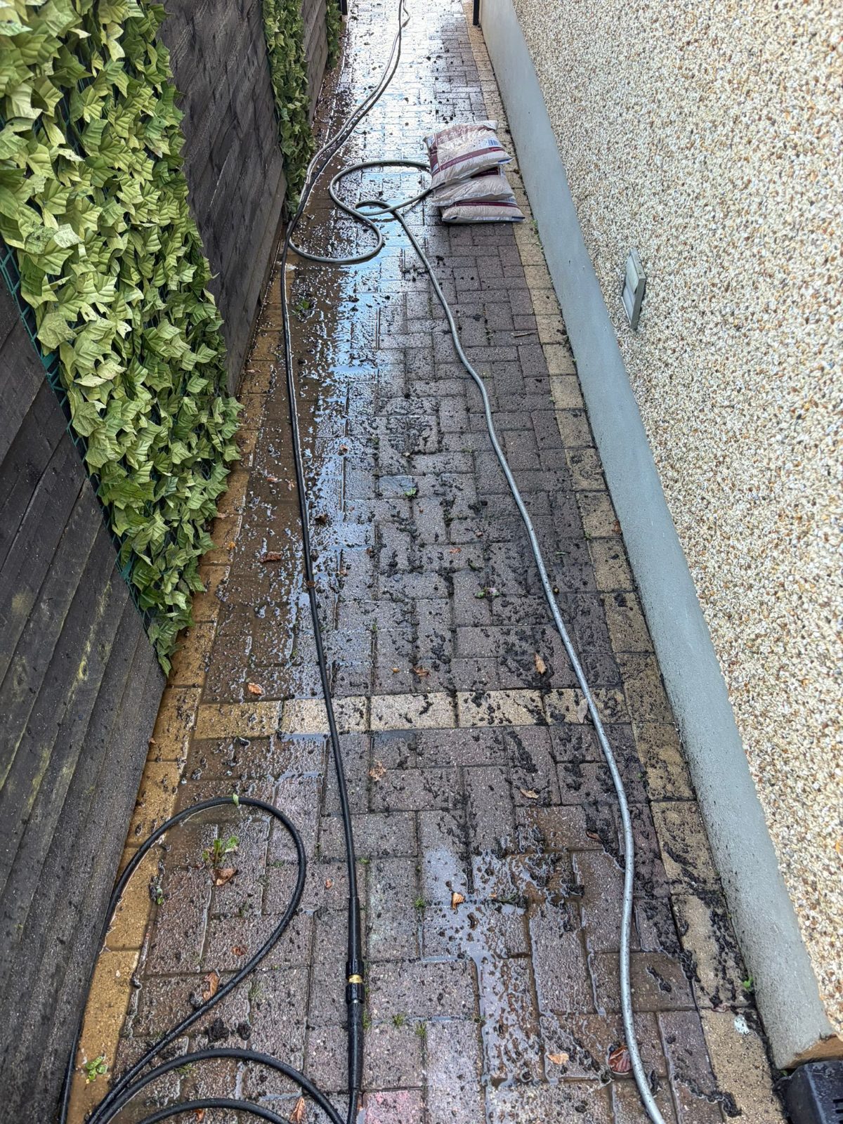 Pressure washing a block paving driveway in Swansea, work in progress