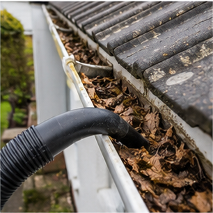 Clearing leaves from a gutter with a vacuum pole