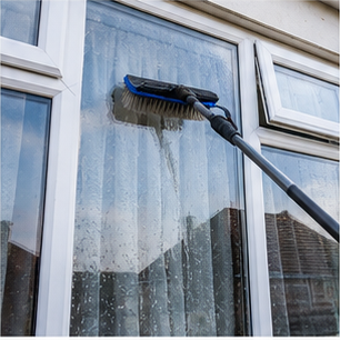 Cleaning a window with a brush and pure water